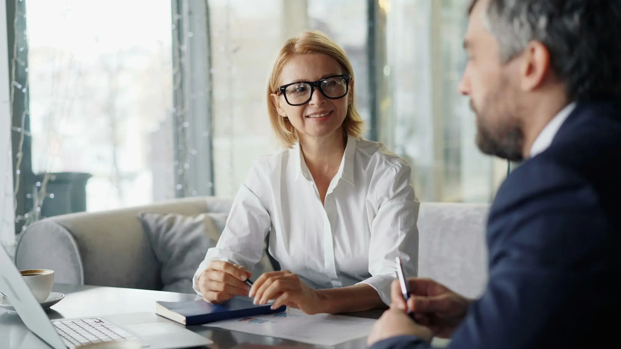 Adviser and client reviewing figures on a laptop