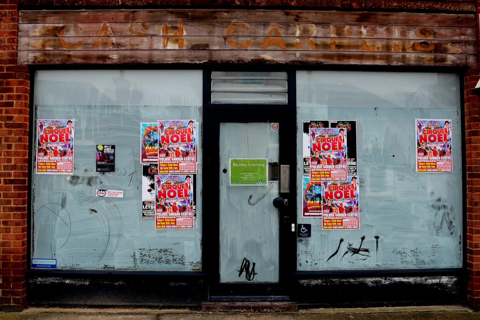 Empty shopfront with posters in the window